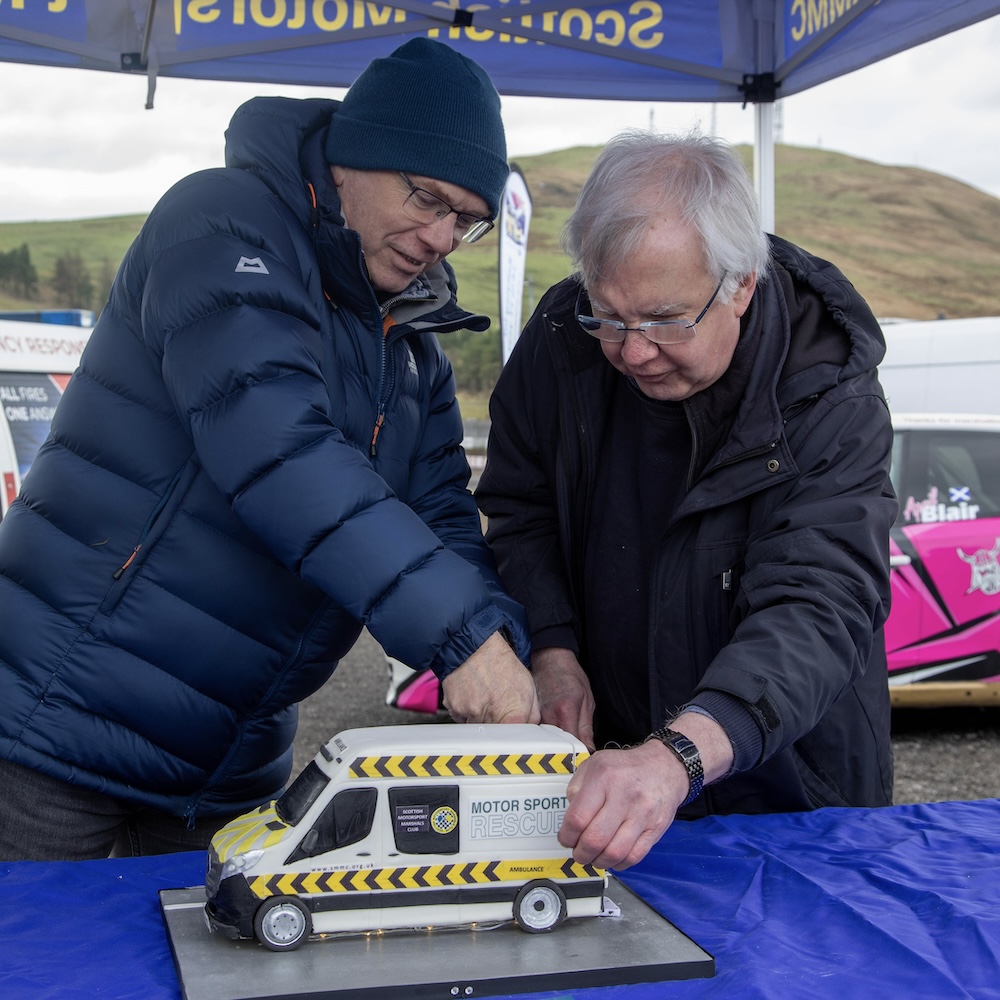 Garry Headridge (left) and Andrew Main cutting the cake at the launch of SMMC's new Motorsport Rescue Ambulance